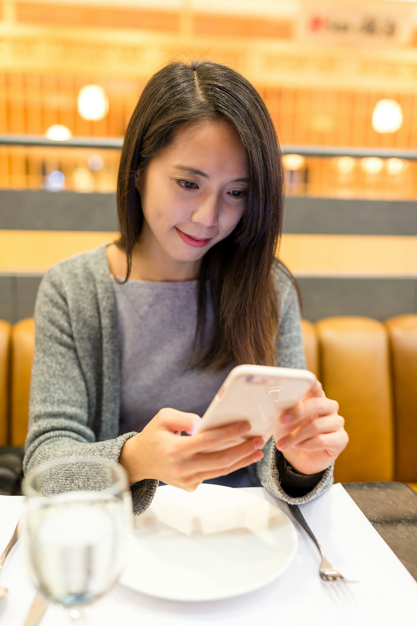 Young Woman use of mobile phone in restaurant